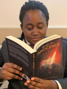 Young African-American girl reading Band of Innocence
